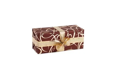 Packaged rectangular gift in dark brown packaging with gold bow and gold pattern Stock Photos