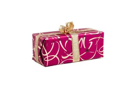 Packaged rectangular gift in dark pink packaging with gold bow and gold pattern Foto stock