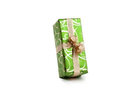 Packaged rectangular gift in green packaging with gold bow and gold pattern on a Foto stock