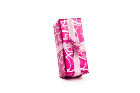 Packaged rectangular gift in pink packaging with gold bow and gold pattern on a Stock Photos