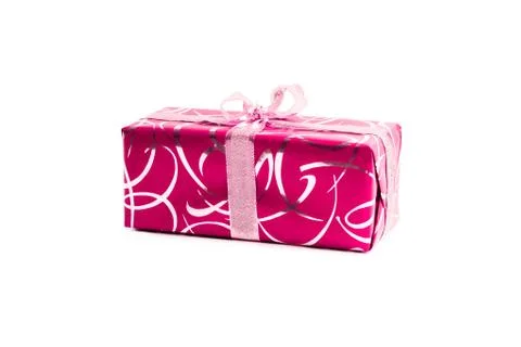 Packaged rectangular gift in pink packaging with gold bow and gold pattern on a Stock Photos