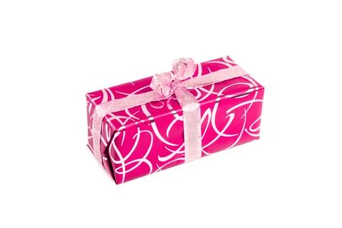 Packaged rectangular gift in pink packaging with gold bow and gold pattern on a Stock Photos