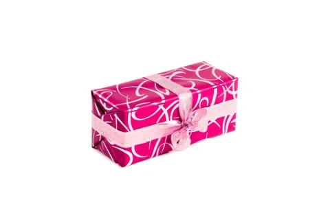 Packaged rectangular gift in pink packaging with gold bow and gold pattern on a Stock Photos