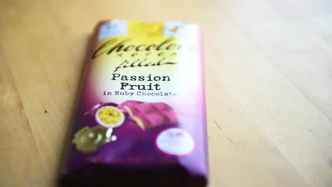 Packaged ruby passion fruit chocolate bar with sign label Chocolove brand Video stock 166640227