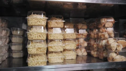 Packaged Shredded Potatoes and Bakery Rolls in Display Case. Stock Footage 321808640