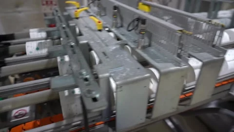 Packaged tissue paper bundles moving along an automated packaging conveyor line Stock Footage 340901899