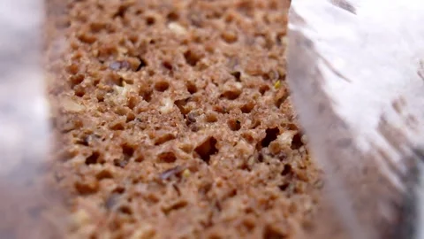 Packaged whole grain sliced bread in open plastic bag Stock Footage 332171959