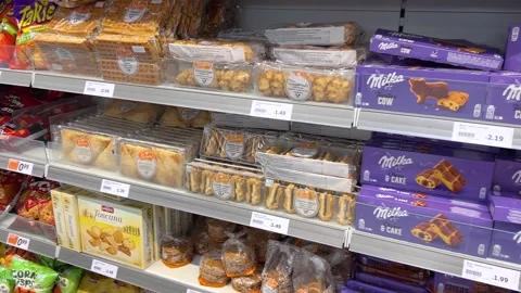 Packages of cookies, peanuts and peanuts and sweets on shelf Stock Footage 312700513