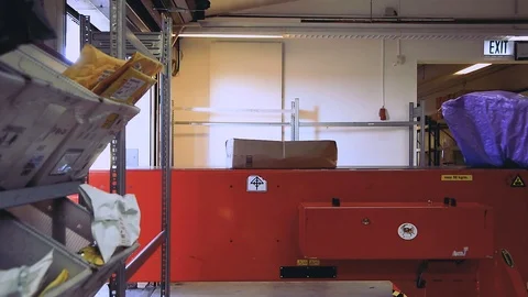 Packages travelling along conveyor at sorting office, Spangahlem Air Base Stock Footage 103586337