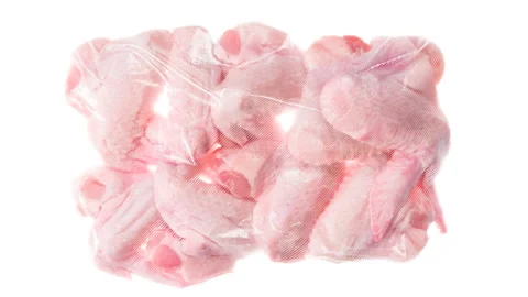 Packaging and Freezing a Batch of Chicken Wings 4K Stock Footage 328022627