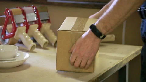 Packaging a box for shipping Stock Footage 132710714