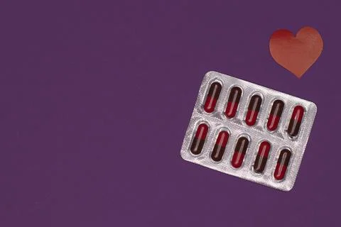 Packaging of capsules, tablets on a purple background to protect and protect the Stock Photos