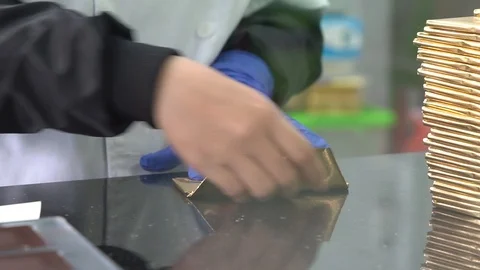 Packaging chocolate bars in wrappers in factory Stock Footage 88936681