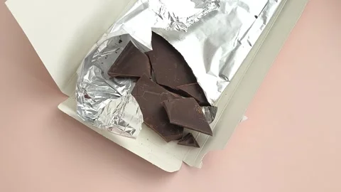Packaging with chocolate in foil close-up on the table. Natural chocolate Stock Footage 324555046