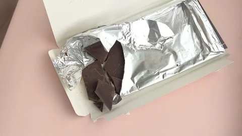 Packaging with chocolate in foil close-up on the table. Natural chocolate Stock Footage 324555051