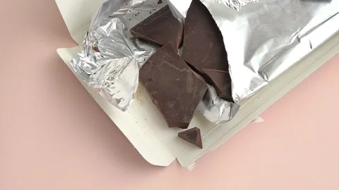 Packaging with chocolate in foil close-up on the table. Natural chocolate Stock Footage 324555071