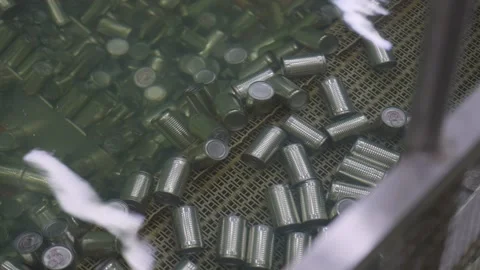 Packaging cleaning process with cans through water on an automated conveyor line Stock Footage 329904674