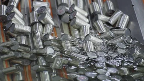 Packaging cleaning process with cans through water on an automated conveyor line Stock Footage 329904680
