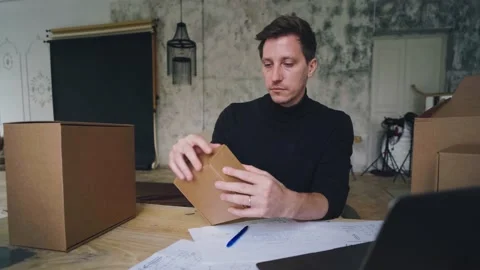 Packaging design, a man develops a box design using a computer and a sketch 스톡 동영상 221278568