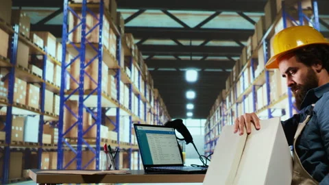 Packaging engineer uses barcode scanner to verify each item Stock Footage 256631091