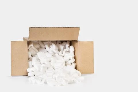 Packaging foam chips inside a brown carboard box Stock Photos