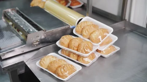 Packaging Fresh Baked Pies in Plastic Trays on Line. Bakery production. Stock Footage 321735609