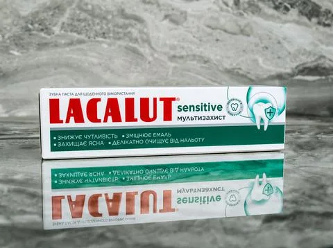 Packaging of LACALUT sensitive toothpaste on a polished marble shelf Stock Photos
