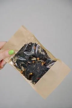 Packaging of loose leaf tea with herbal additives in a craft bag Stock Photos