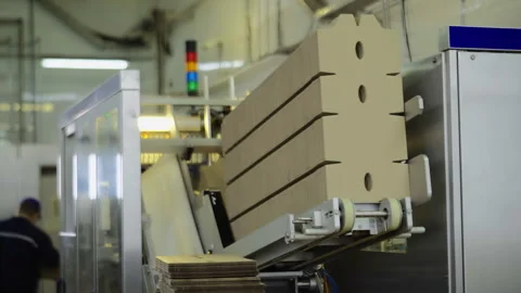 The packaging machine is putting the cardboard boxes on the production line Stock Footage 273315237
