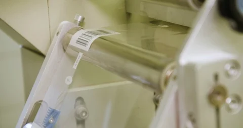 Packaging machine using plastic foil with barcode on the edge Stock Footage 125112480