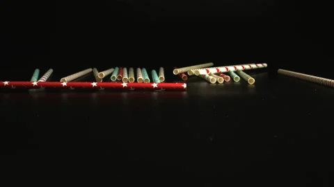 Packaging of paper drinking straws falling onto a black surface. Drinking straws Stock Footage 144384066