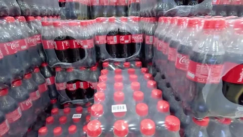 Packaging of plastic Coca-Cola bottles in film on pallets for sale in retail and Video stock 264095238