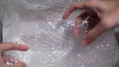 Packaging process: bubble wrap placed in paper box Video stock 313135763