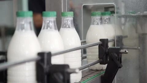 Packaging process of milk production. White plastic bottles transported on 스톡 동영상 106155855
