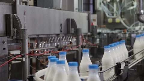 Packaging process of milk production. White plastic bottles transported on Stock Footage 106156759
