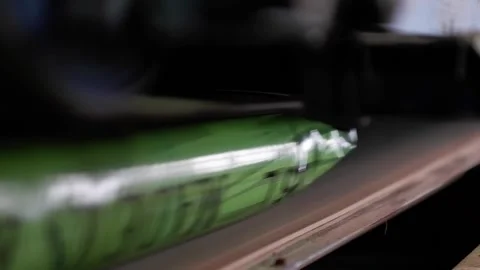The packaging with the products passes through the sealer. Belt press for sea Stock Footage 172452781