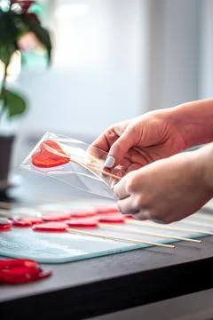 Packaging of red lollipops in the shape of hearts. Stock Photos
