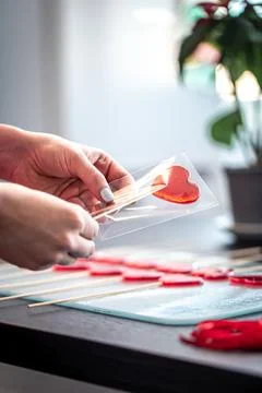 Packaging of red lollipops in the shape of hearts. Stock Photos
