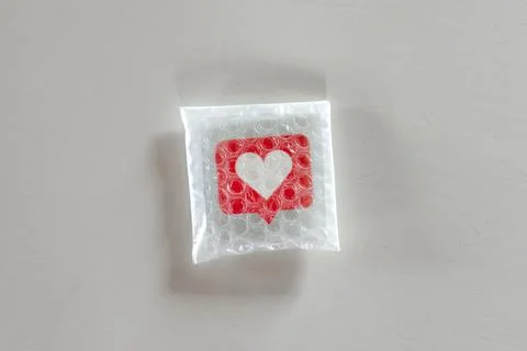 Packaging social Like icon with bubble wrap Stock Photos