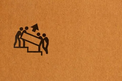 Packaging symbol to indicate which side is up and needs more people to lift Stock Photos