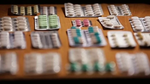 Packaging of tablets and pills on the table Stock Footage 77922728