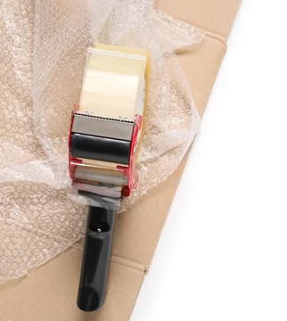 Packaging tape dispenser with bubble wrap and cardboard box for shipping and  Stock Photos