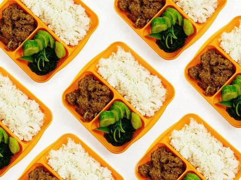 Packed Bento Lunch Boxes With Rice, Savory Beef and Fresh Cucumber Slices Stock Photos