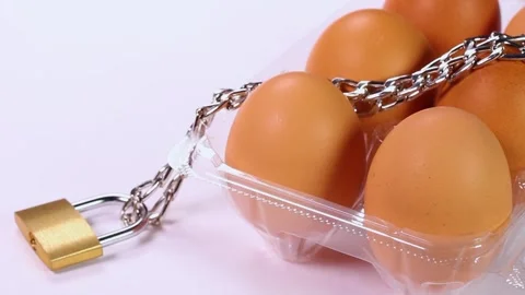 Packed eggs with chain and padlock : rotating Stock Footage 322951460