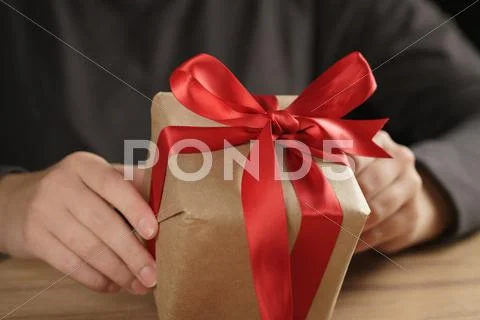 Packed gift box with red ribbon and bow Stock Photos