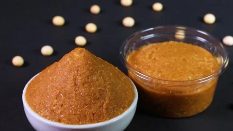 Packed miso, miso in a small bowl and soybeans - rotating Stock Footage 305359212