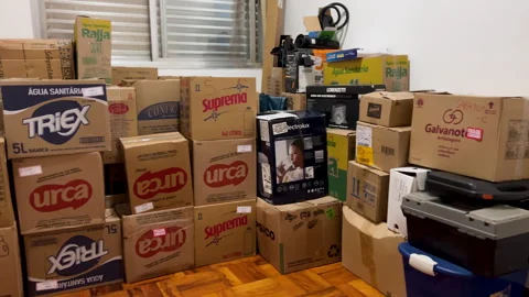Packed moving boxes inside new apartment relocation and house moving concept Stock Footage 335181428