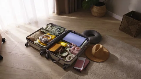 Packed open suitcase with clothes on floor. Preparation, getting ready for 動画素材 252528552