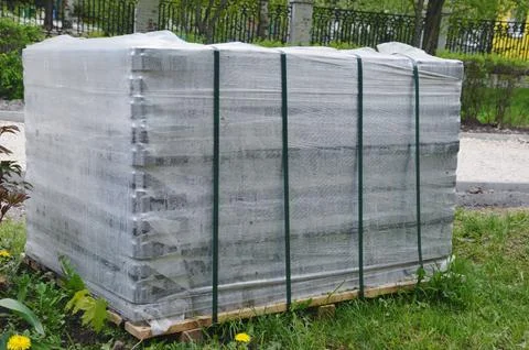 Packed pallets of paving slabs, ready for installation. City sidewalk repairs Foto stock