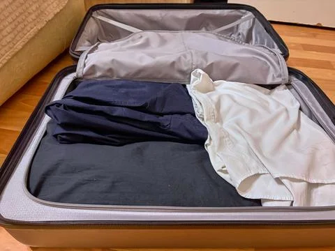 Packed suitcase with things. Packing your suitcase before the trip. Stock Photos